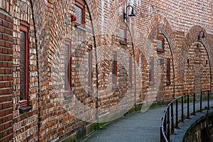 Curved brick wall with doorways and windows as a patterned background