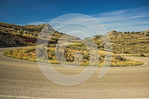 Curved car road in rock mountain nature landscape in dry weather summer time Mediterranean sea district
