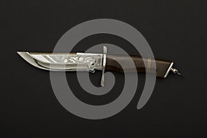 Curved ceremonial dagger with ornate sheath on a black background.Hunting dagger knife with decorative shell isolated on a  backgr