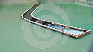 Curved channel with pumped water in the middle of a dam