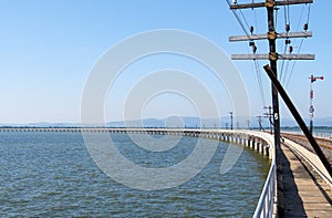 Curved concrete bridge of the railway line along the reservoir