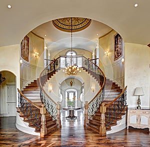 The curved dual grand staircase in an upscale home.