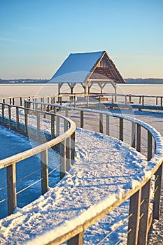 curved footbridge over lake in northern Germany in Winter