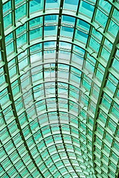 Curved glass roof, Ceiling with arch. Openwork glazing of modern building. Bottom view. Graphic texture, Background