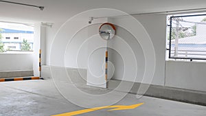 The curved glass with security camera is installed at the corner of the parking building to prevent accidents from driving in the