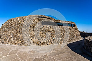 Curved Inclined Wall Made from Stone. The Rock Shed on Sunny Day