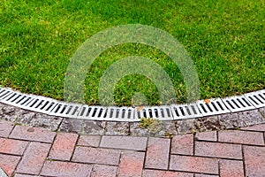 Curved iron grid drainage system in the park.