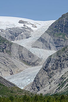 Curved Nigardsbreen glacier in the rocky valley, Norway