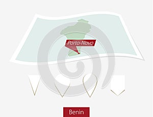 Curved paper map of Benin with capital Abuja on Gray Background