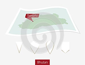 Curved paper map of Bhutan with capital Thimphu on Gray Background. Four different Map pin set.