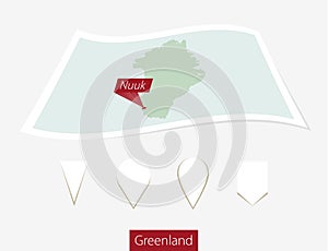 Curved paper map of Greenland with capital Nuuk on Gray Background. Four different Map pin set.