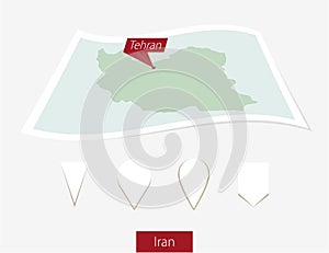 Curved paper map of Iran with capital Tehran on Gray Background