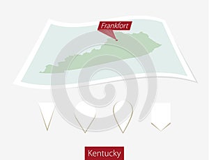 Curved paper map of Kentucky state with capital Frankfort on Gray Background. Four different Map pin set.