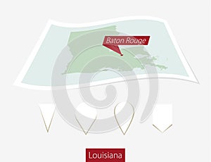 Curved paper map of Louisiana state with capital Baton Rouge on
