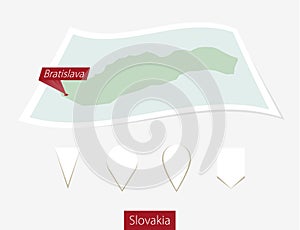 Curved paper map of Slovakia with capital Bratislava on Gray Background. Four different Map pin set.