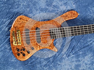 Curved patterned wood bass guitar body