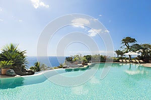 Curved pool with turquoise water over dark blue ocean, Tenerife. Spain