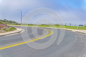 Curved road with double yellow lanes at Laguna Niguel in Southern California