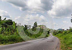 Curved and disappearing rural road Ekiti State Nigeria. Ekiti hills, disappearing road,  photo