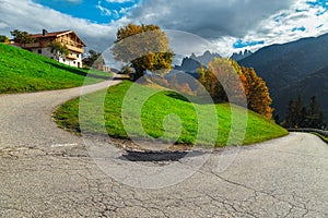 Curved rural road on the mountain pass in the Dolomites