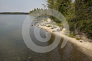 Curved, sandy shoreline of Jenny Lake, Jackson Hole, Wyoming.