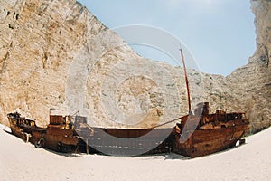Curved ship on Zakynthos island, Greece Navagio beach, or shipwreck beach,sometimes called smugglers ` Bay , on the coast of