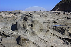 Curved smooth grey beach rocks