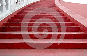 The curved stairway is painted red