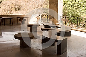 Curved stone bank with round stools