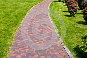 Curved stone tile pavement crescent path.