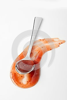 Curved swathe and spoon full of savory sauce photo