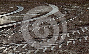 Curved tracks of a tractor on frozen ground