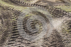 Curved tractor tracks in the mud