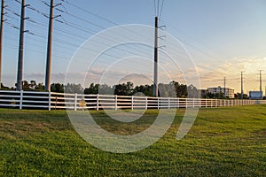 Curved white wooden fence alongside