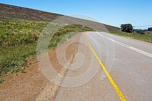 Curving Ashphalt Road with Yellow and White lines photo