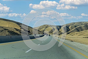 Curving asphalt road between Baku and Shamakhi districts and hills in background, Azerbaijan