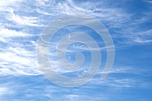 Curving Cirrus clouds in blue sky. Background.