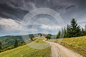 Curving dirt road on the top of the mountains in the Carpathian mountains, Romania