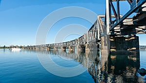 Curving lines of historic steel truss railway bridge