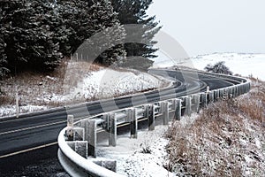 Curving road through snow covered hills