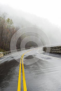 Curving Smoky Mountain Road Disappears Into Fog With Copy Space