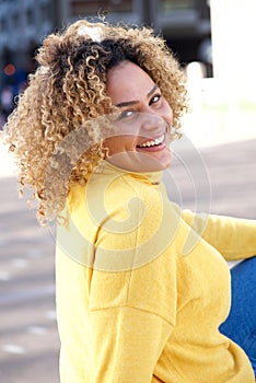 Curvy african american woman sitting outside