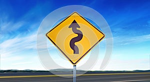Curvy Arrow Symbol - Yellow Road Sign Isolated on Sky Background with Room for Copy