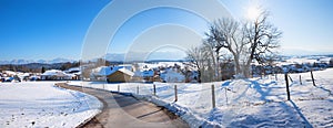 Curvy country road to Aidling village, blue land upper bavaria in winter