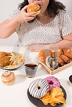 Curvy female preparing to eat hamburger, overeating problem, depression