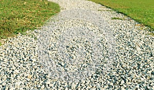 Curvy gravel path in the morning sunlight