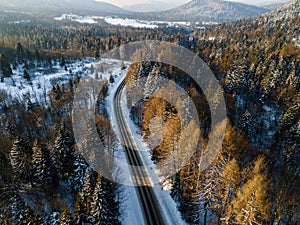 Curvy Road Brodge over Frozen River. Winter Landscape in Mountains. Bieszczady Poland. Drone Top Down View