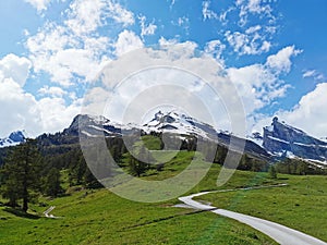 Curvy road in the mountains with mountaintops in background