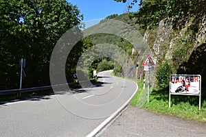 curvy road in Our vally with warning signs, falling rocks and speed checks