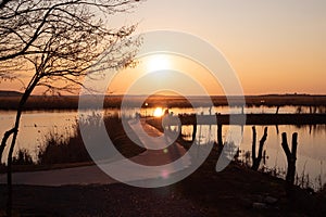 Curvy road over Comana lake at sunset